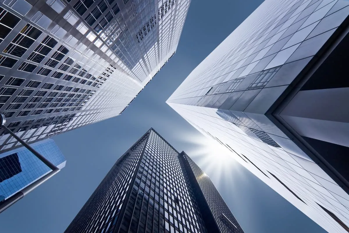 Looking up at high-rise office buildings against a clear sky